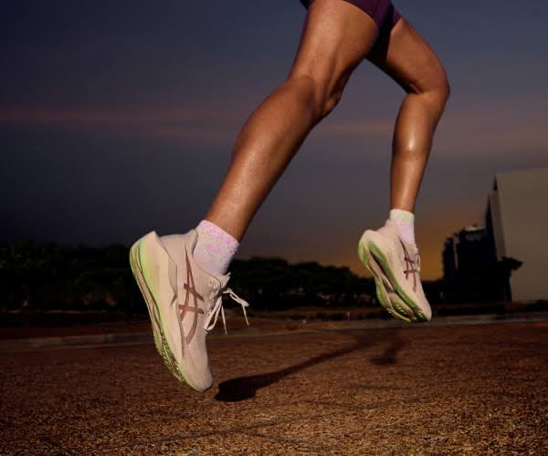 Running shoes mid-stride at dusk