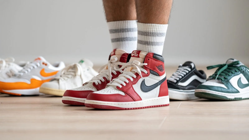 Pre-loved sneakers lined up on a wooden floor